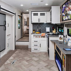 265 RDS Creative cooks appreciate the user-friendly kitchen layout in this all new fifth wheel model, with a large pantry, abundant storage, and contemporary decor. When it’s time to turn in, step up to a large front bedroom and bath. Easily access slides, awning, interior and porch lights, the water pump and heater, plus battery and tank capacities from one centrally located Convenience Center panel. Stay charged – handy USB ports are located throughout. The TV can be repositioned for the best view. Shown in Cafe Latte decor, with these options: TV, 8 cu. ft. gas/electric refrigerator and Limited Edition Package.