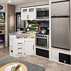 382 THS After an active day of fun in the outdoors, Puma is a great place to whip up a delicious meal in this well-equipped kitchen. Easily access under sink storage from both sides of this L-Shaped galley. Cafe Latte decor shown with these options: XL Edition Package and TV.